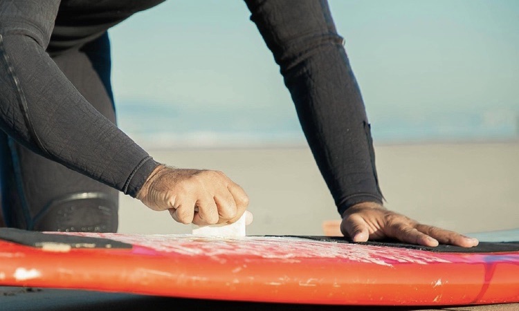 waxing a surfboard